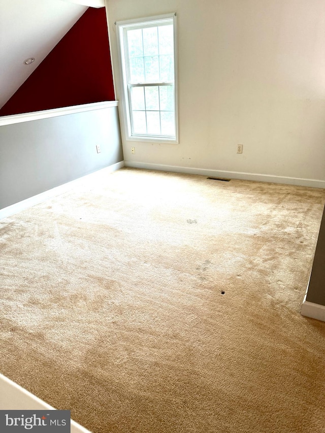 bonus room with carpet flooring and lofted ceiling