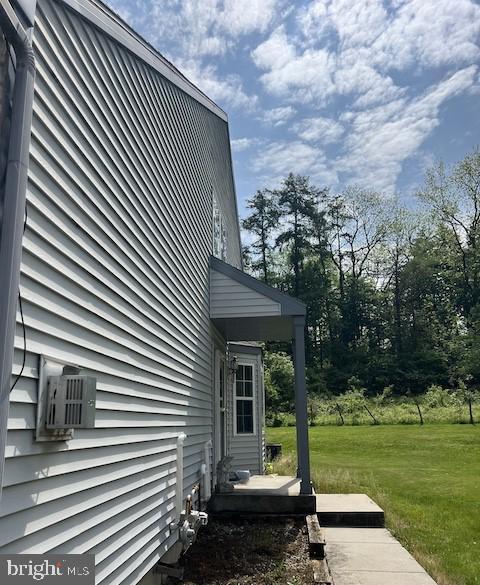 view of side of property with a lawn