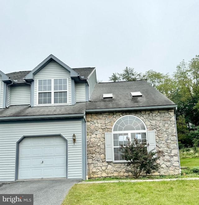 view of front of property with a front yard and a garage