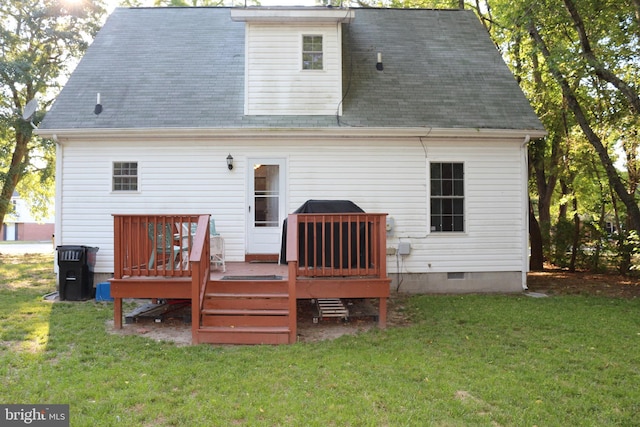 back of house featuring a lawn and a deck