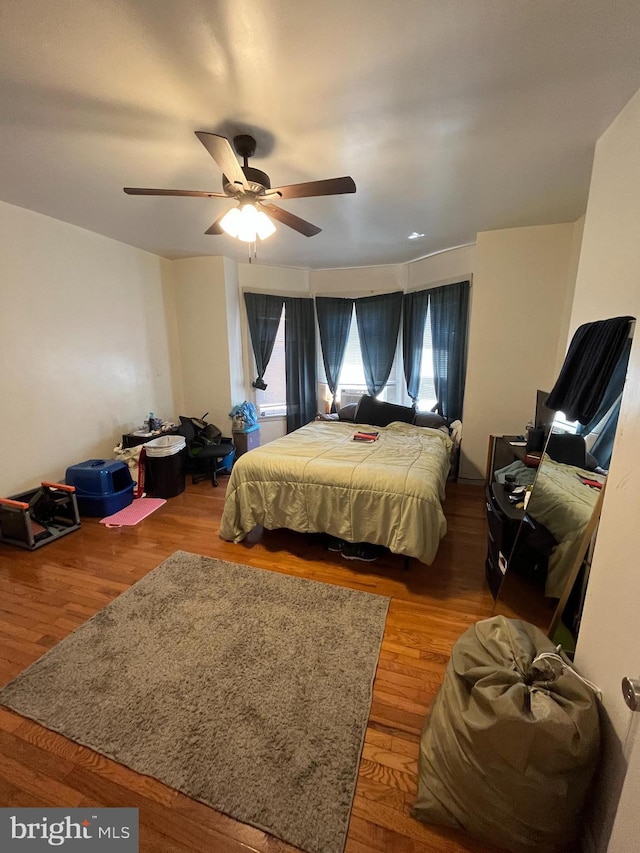 bedroom with ceiling fan and wood-type flooring