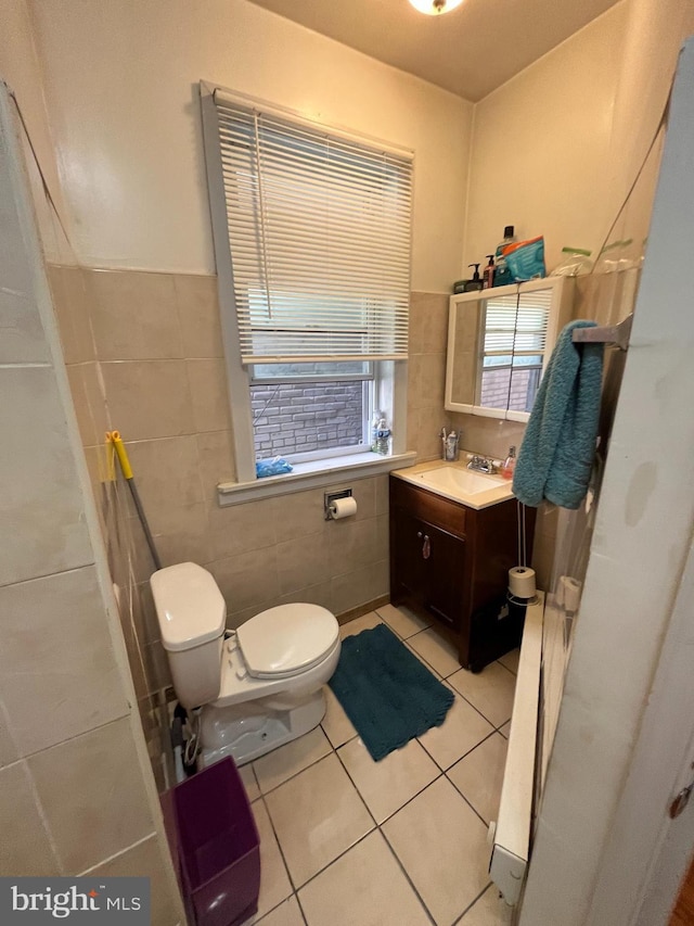 bathroom featuring tile patterned flooring, vanity, tile walls, and toilet