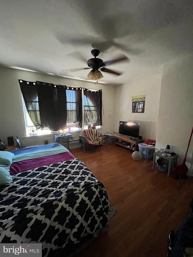 bedroom with hardwood / wood-style floors and ceiling fan