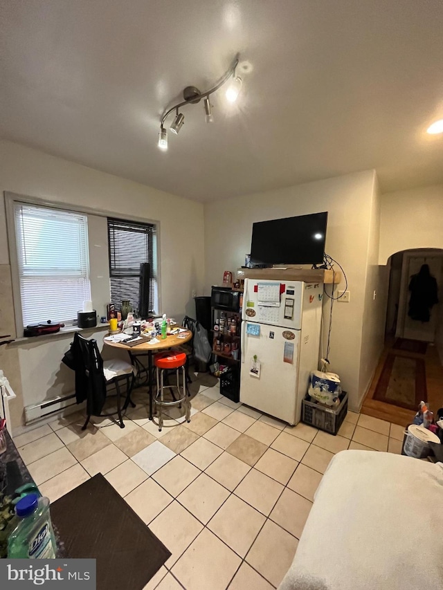 dining room with light tile patterned floors and a baseboard radiator