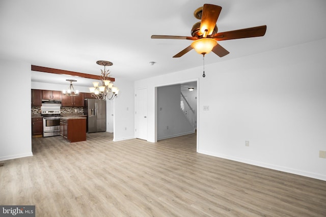 unfurnished living room with ceiling fan with notable chandelier and light hardwood / wood-style flooring