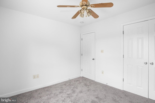 unfurnished bedroom with ceiling fan, light colored carpet, and a closet