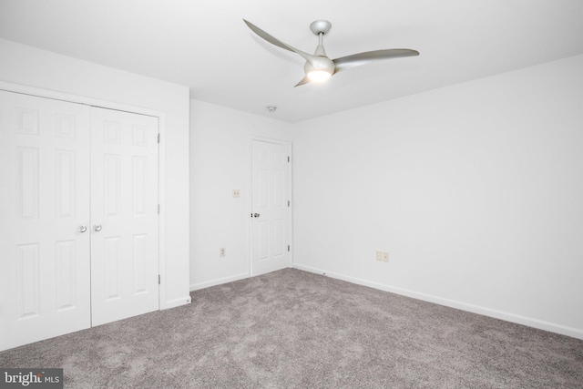 unfurnished bedroom featuring ceiling fan, a closet, and carpet floors