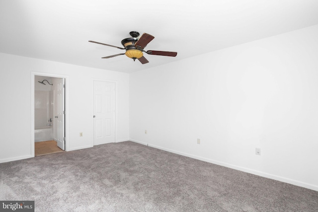 unfurnished bedroom featuring light carpet, ceiling fan, and connected bathroom