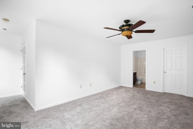 unfurnished bedroom featuring ceiling fan, ensuite bathroom, and carpet flooring