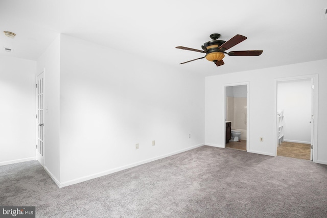 unfurnished bedroom with ceiling fan, light carpet, and ensuite bath