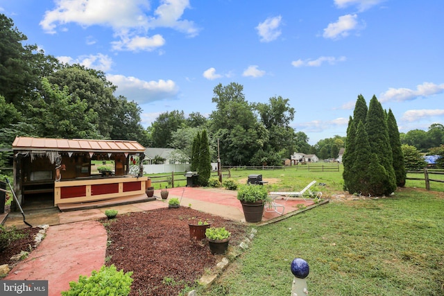 view of yard featuring a rural view and a patio area