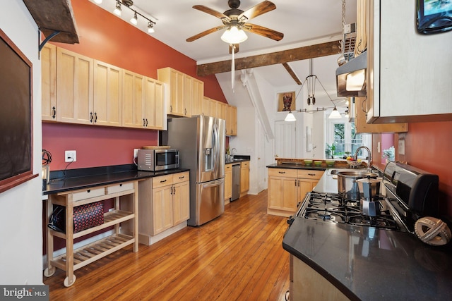 kitchen with appliances with stainless steel finishes, ceiling fan, sink, light brown cabinets, and hanging light fixtures