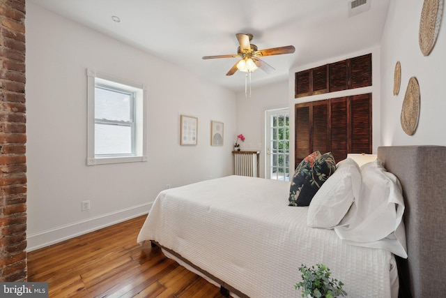 bedroom with hardwood / wood-style floors and ceiling fan