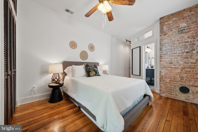 bedroom with hardwood / wood-style flooring, ceiling fan, and ensuite bathroom