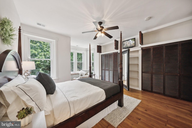 bedroom with dark hardwood / wood-style floors and ceiling fan