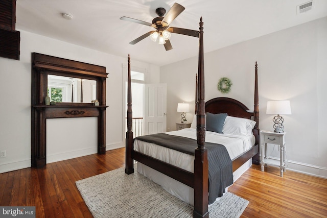 bedroom with ceiling fan and hardwood / wood-style floors