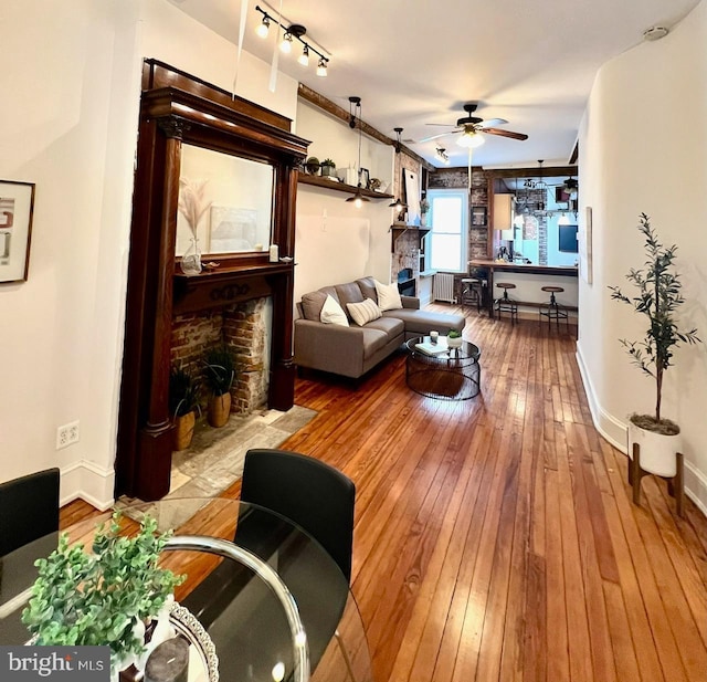 living room with ceiling fan and hardwood / wood-style floors