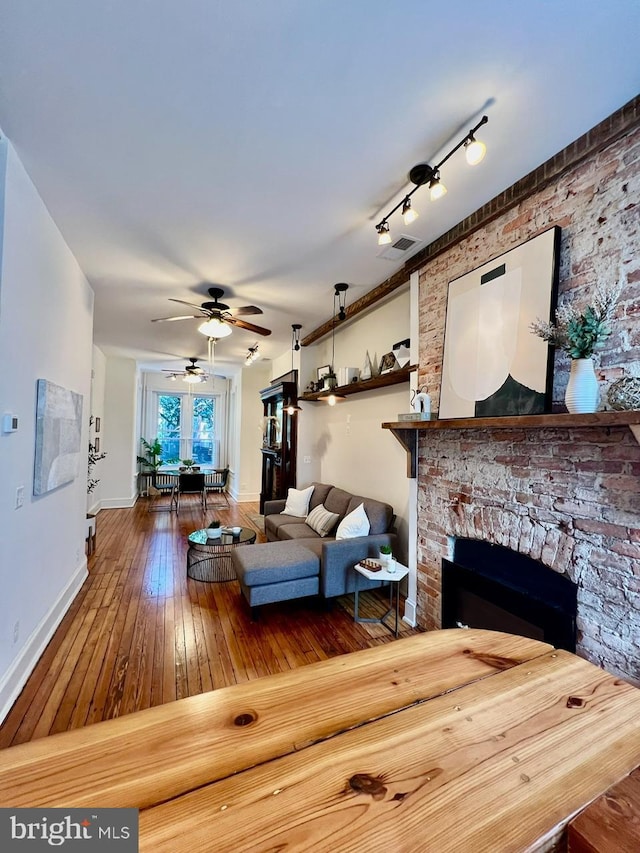 living room featuring hardwood / wood-style flooring and ceiling fan