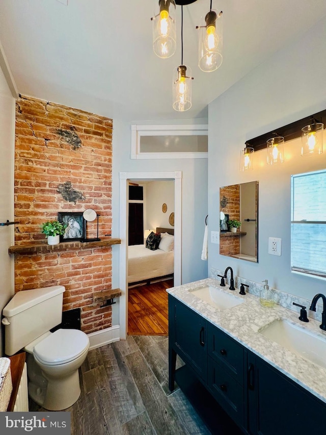 bathroom featuring vanity, wood-type flooring, and toilet