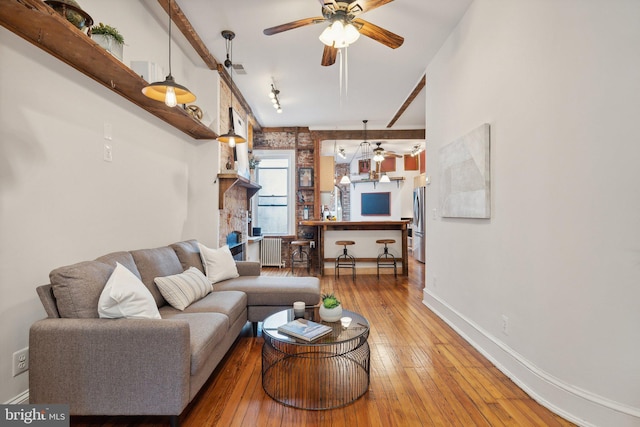 living room featuring wood-type flooring and radiator heating unit