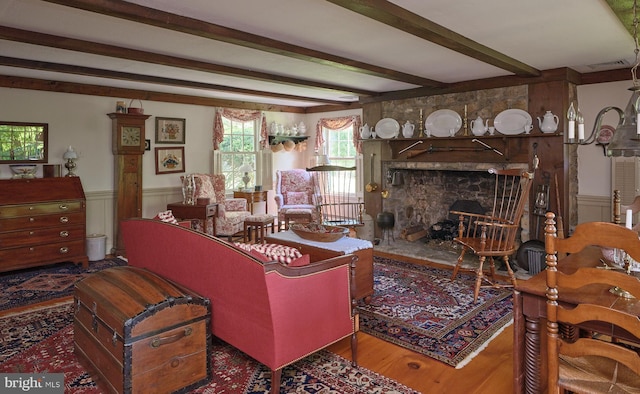 living room featuring beam ceiling and hardwood / wood-style flooring