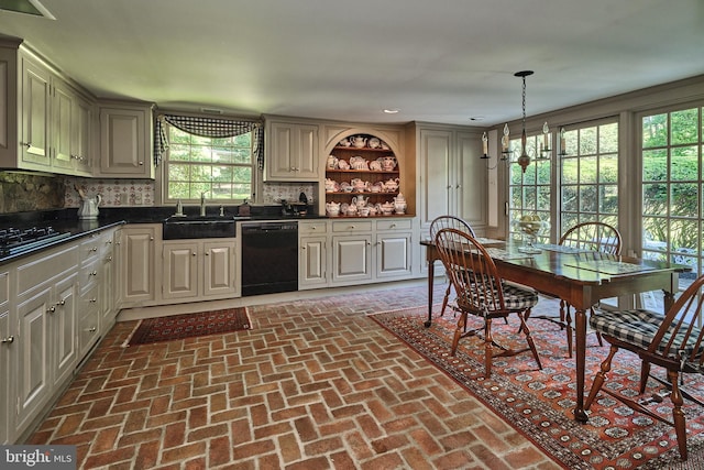 kitchen featuring dishwasher, backsplash, sink, decorative light fixtures, and a chandelier