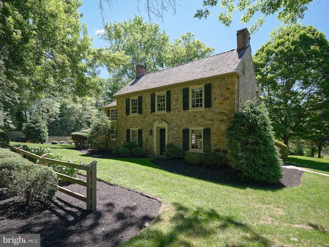 colonial-style house with a front lawn