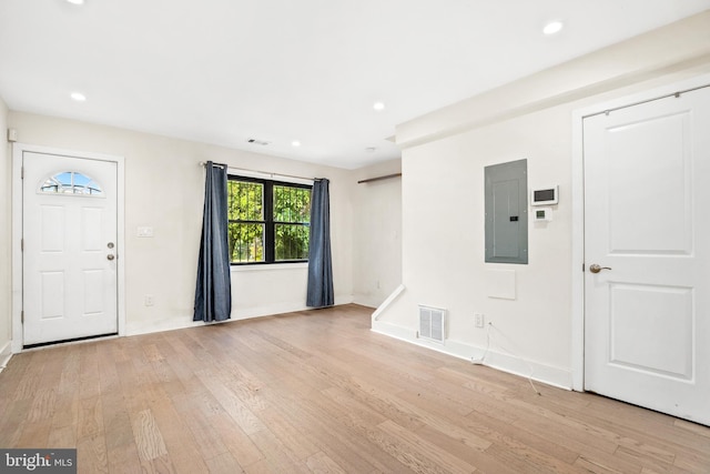 foyer featuring electric panel and light wood-type flooring