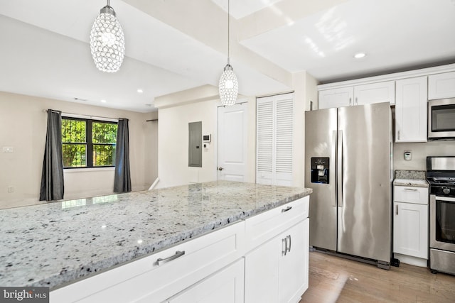 kitchen featuring white cabinetry, hanging light fixtures, and appliances with stainless steel finishes