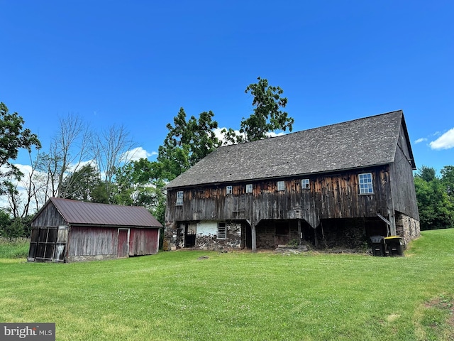 view of outdoor structure featuring a lawn