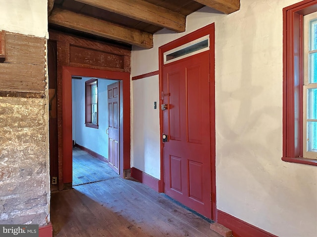 corridor featuring beam ceiling and wood-type flooring