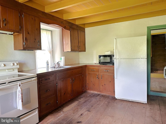 kitchen featuring wooden ceiling, white appliances, sink, light hardwood / wood-style flooring, and beam ceiling