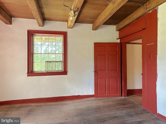 interior space featuring beam ceiling, dark hardwood / wood-style floors, and wood ceiling