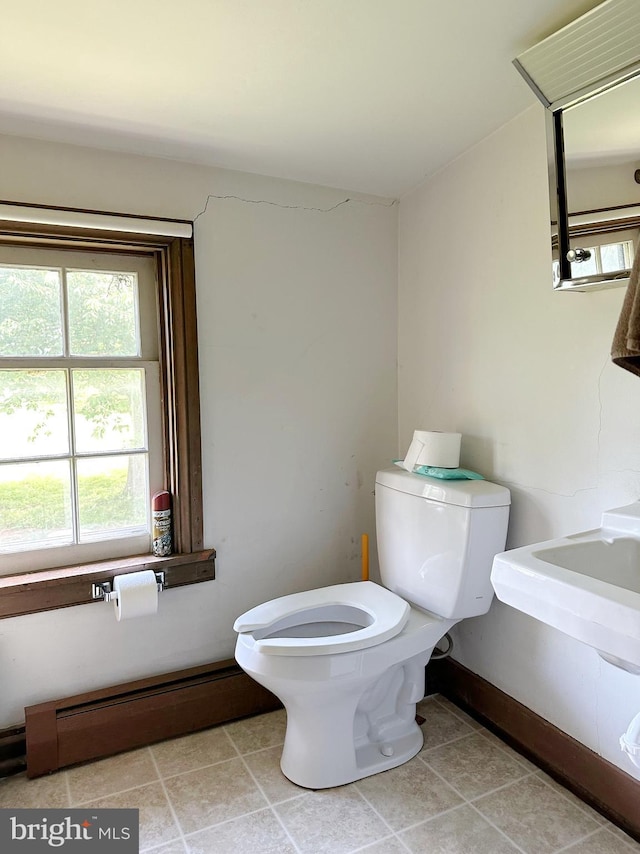 bathroom featuring tile patterned floors, a baseboard radiator, and toilet