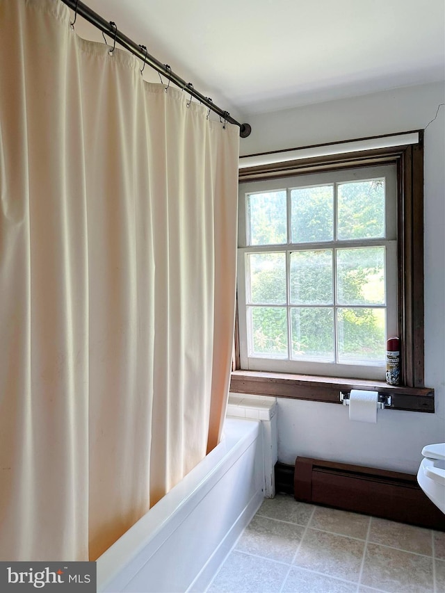 bathroom featuring shower / bathtub combination with curtain and a baseboard radiator