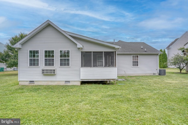 rear view of property featuring central AC, a sunroom, and a yard