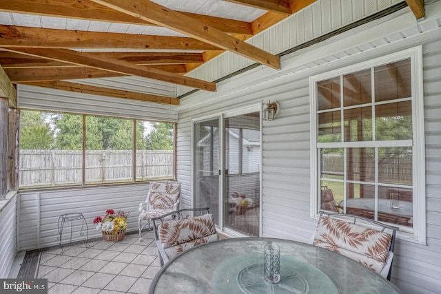 unfurnished sunroom with vaulted ceiling with beams and wooden ceiling