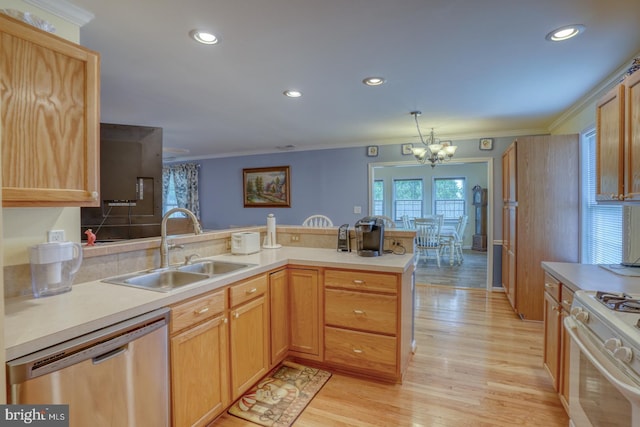 kitchen featuring dishwasher, an inviting chandelier, sink, light hardwood / wood-style floors, and kitchen peninsula