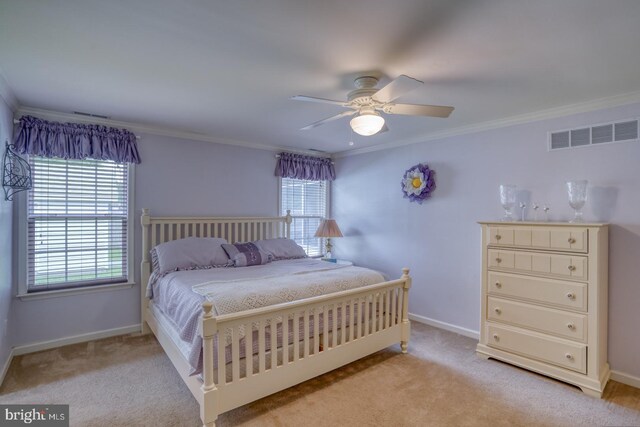 bedroom featuring light colored carpet, multiple windows, crown molding, and ceiling fan