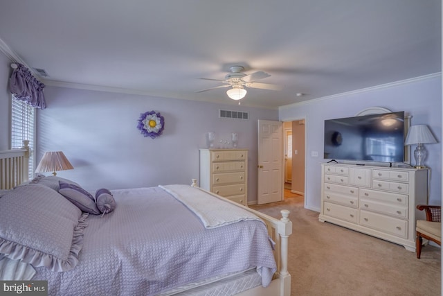 carpeted bedroom featuring ceiling fan and ornamental molding