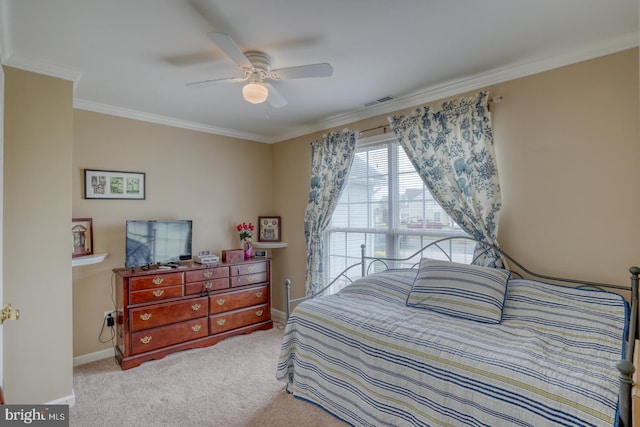 bedroom featuring ceiling fan, crown molding, and light carpet