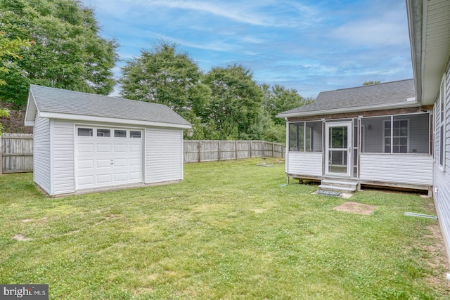 view of yard with a garage and an outdoor structure