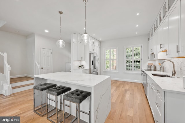 kitchen with white cabinets, appliances with stainless steel finishes, and a center island