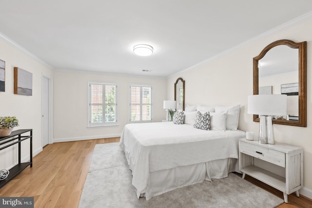 bedroom featuring light wood-type flooring and crown molding