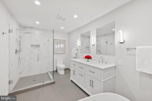 bathroom featuring an enclosed shower, vanity, toilet, and tile patterned flooring