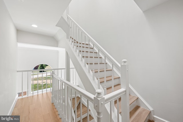 stairway featuring wood-type flooring