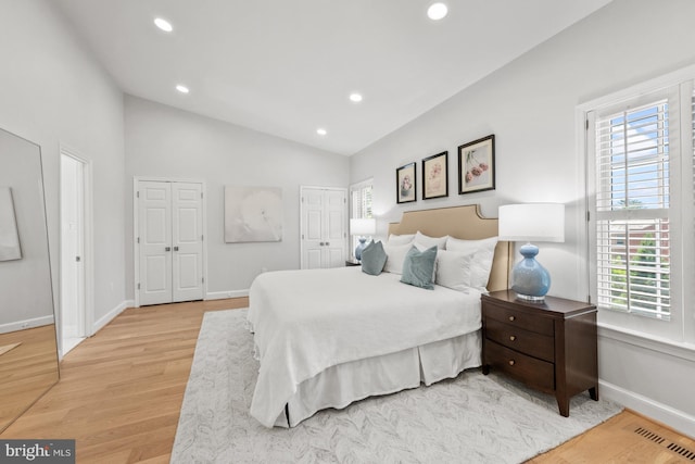 3604 Winfield Ln NW, Washington, DC 20007 - bedroom featuring multiple windows, two closets, light wood-style flooring, recessed lighting, and lofted ceiling