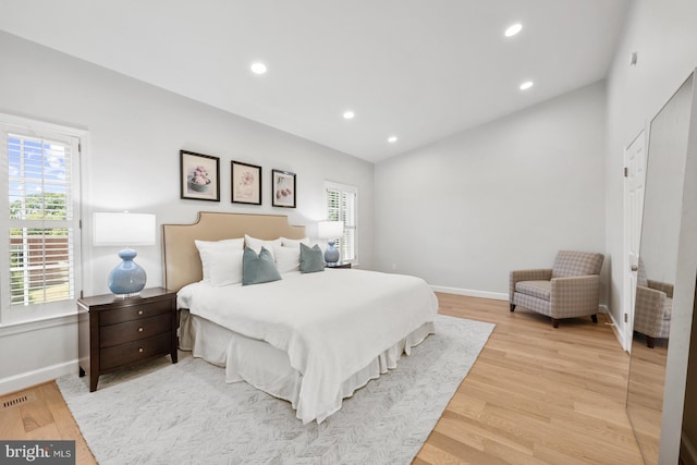 bedroom featuring multiple windows and wood-type flooring