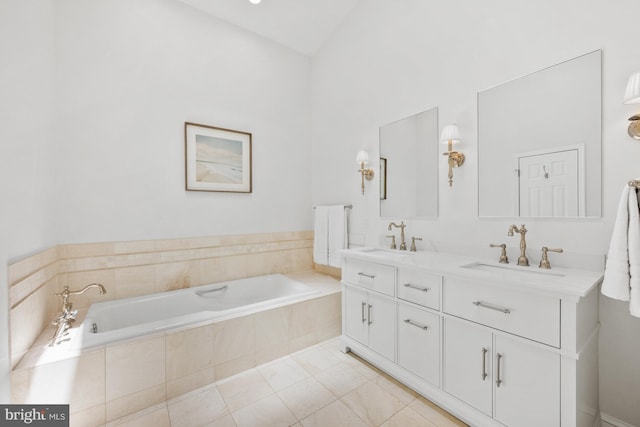 bathroom featuring tile patterned floors, vanity, and a relaxing tiled tub