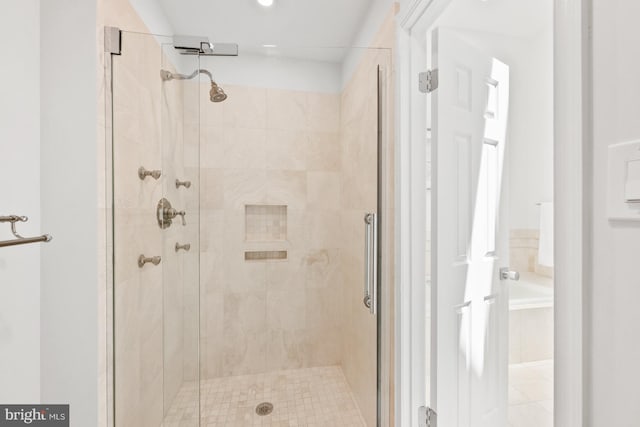 bathroom featuring a shower with shower door